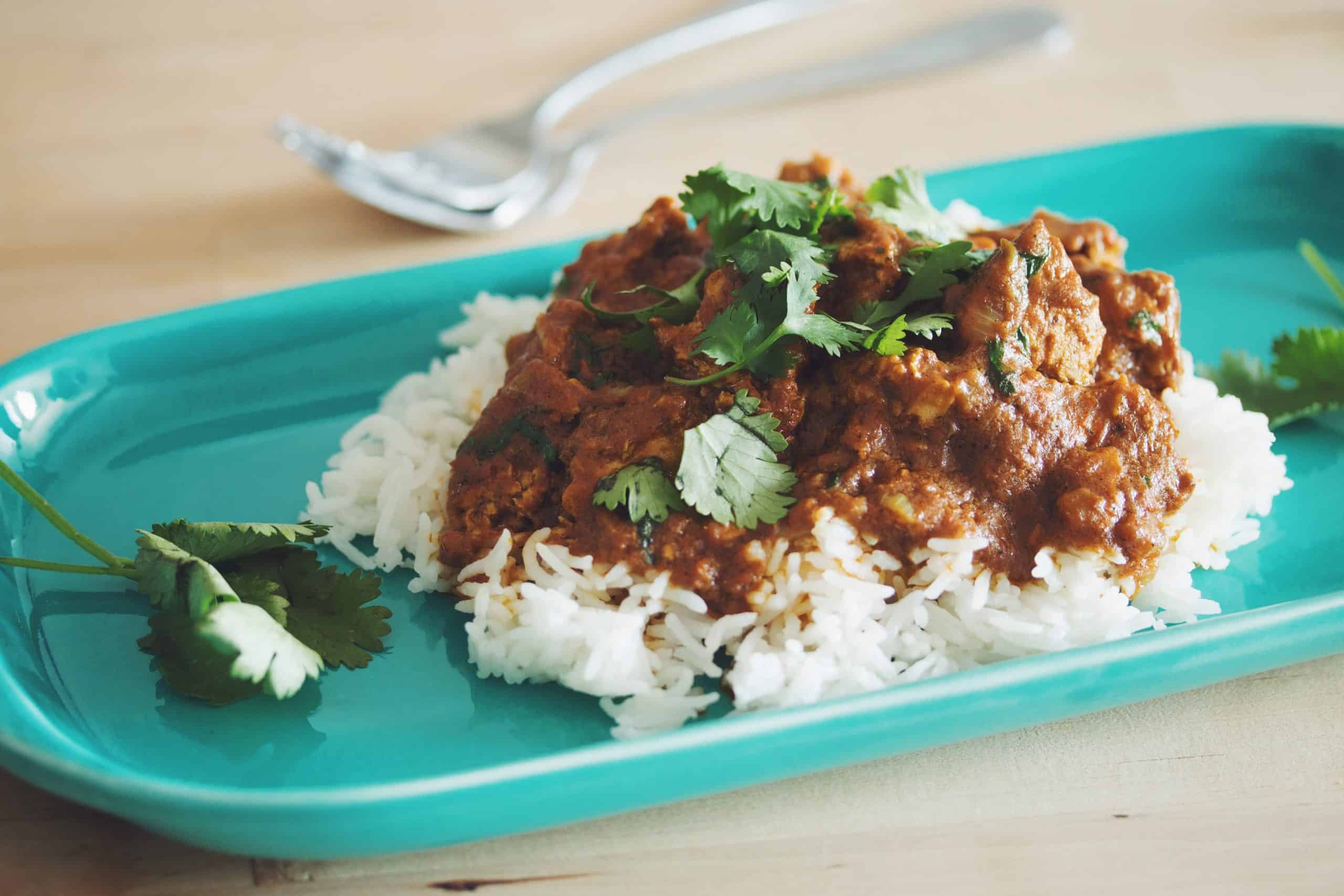 plate of vegan butter chicken on rice