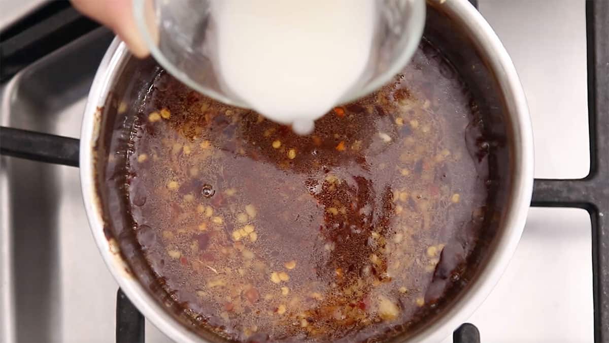 sauce pan of sweet and sour sauce being prepared