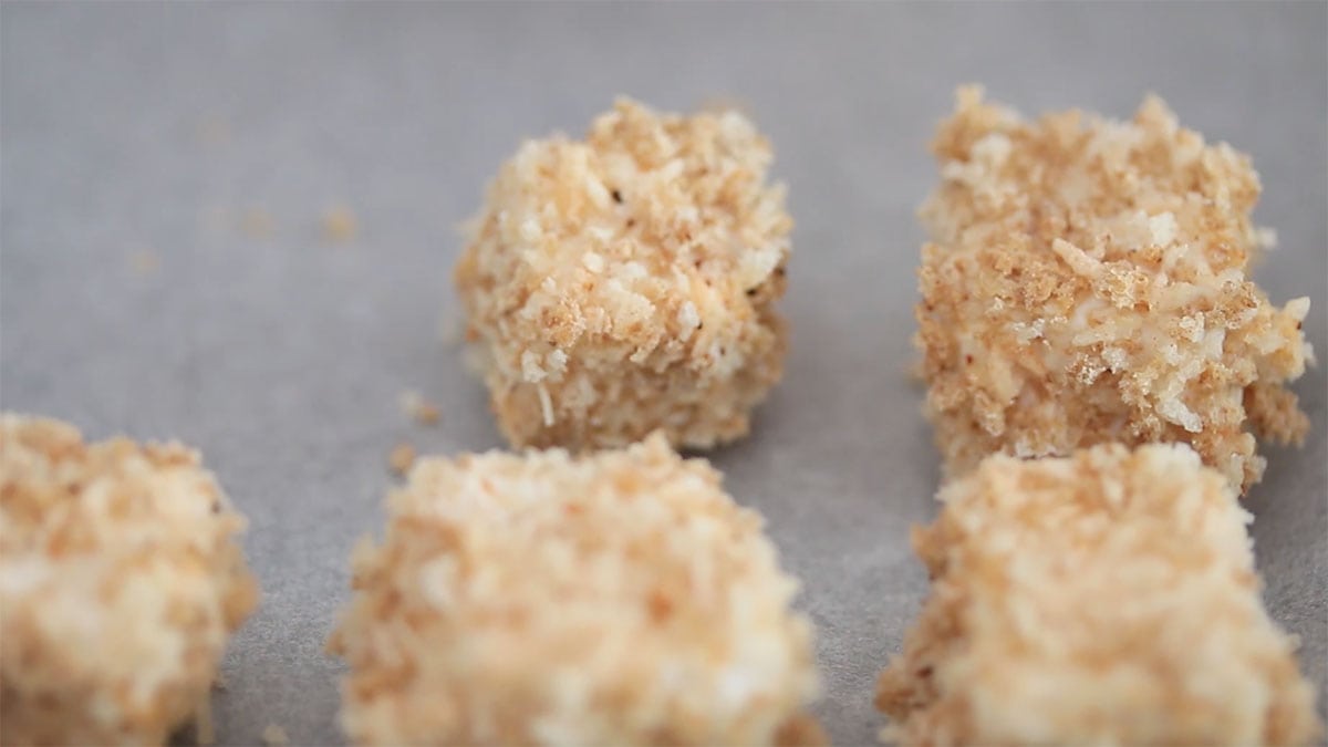 battered tofu cubes on a baking sheet
