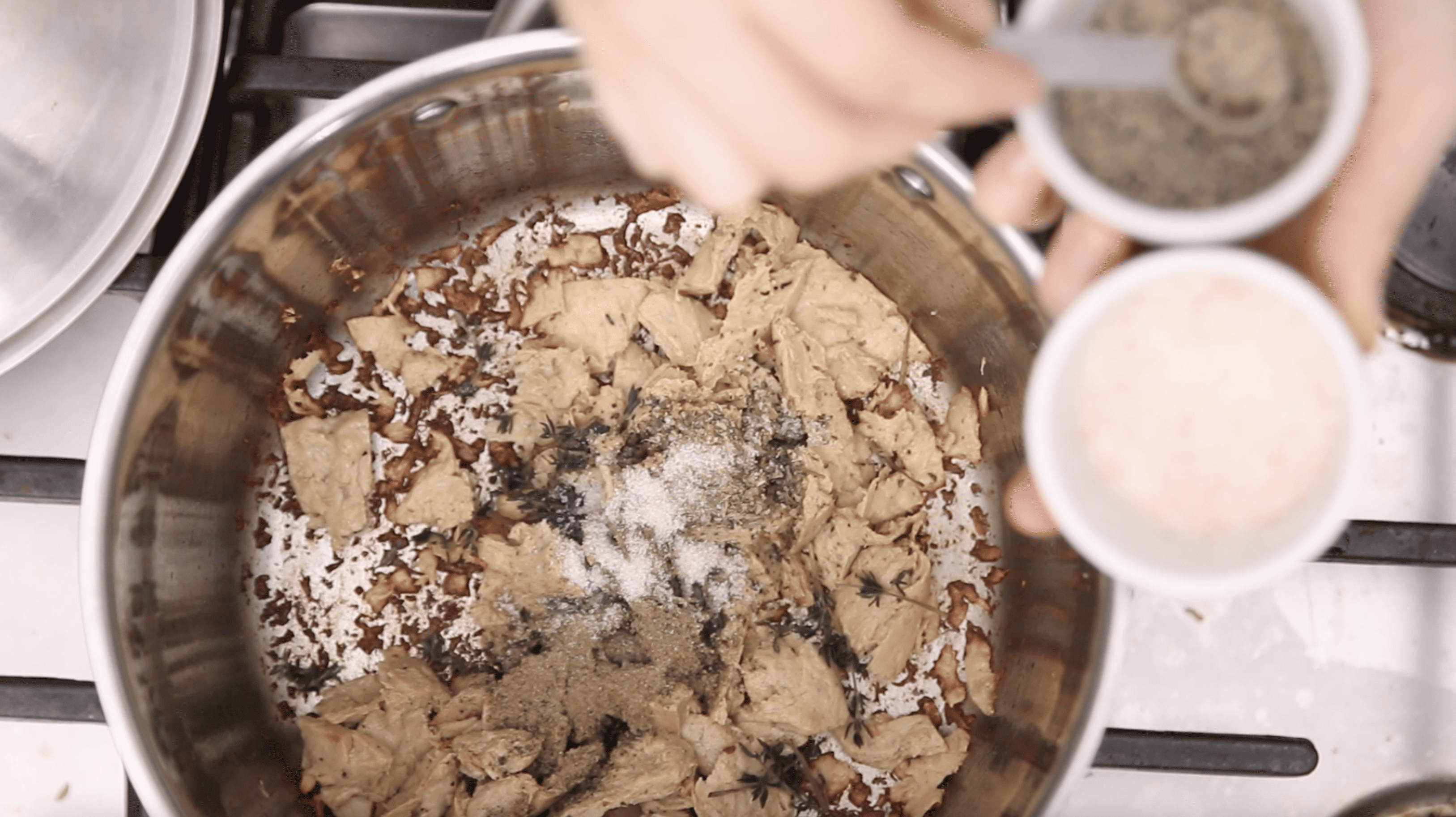 adding spices to vegan chicken noodle soup