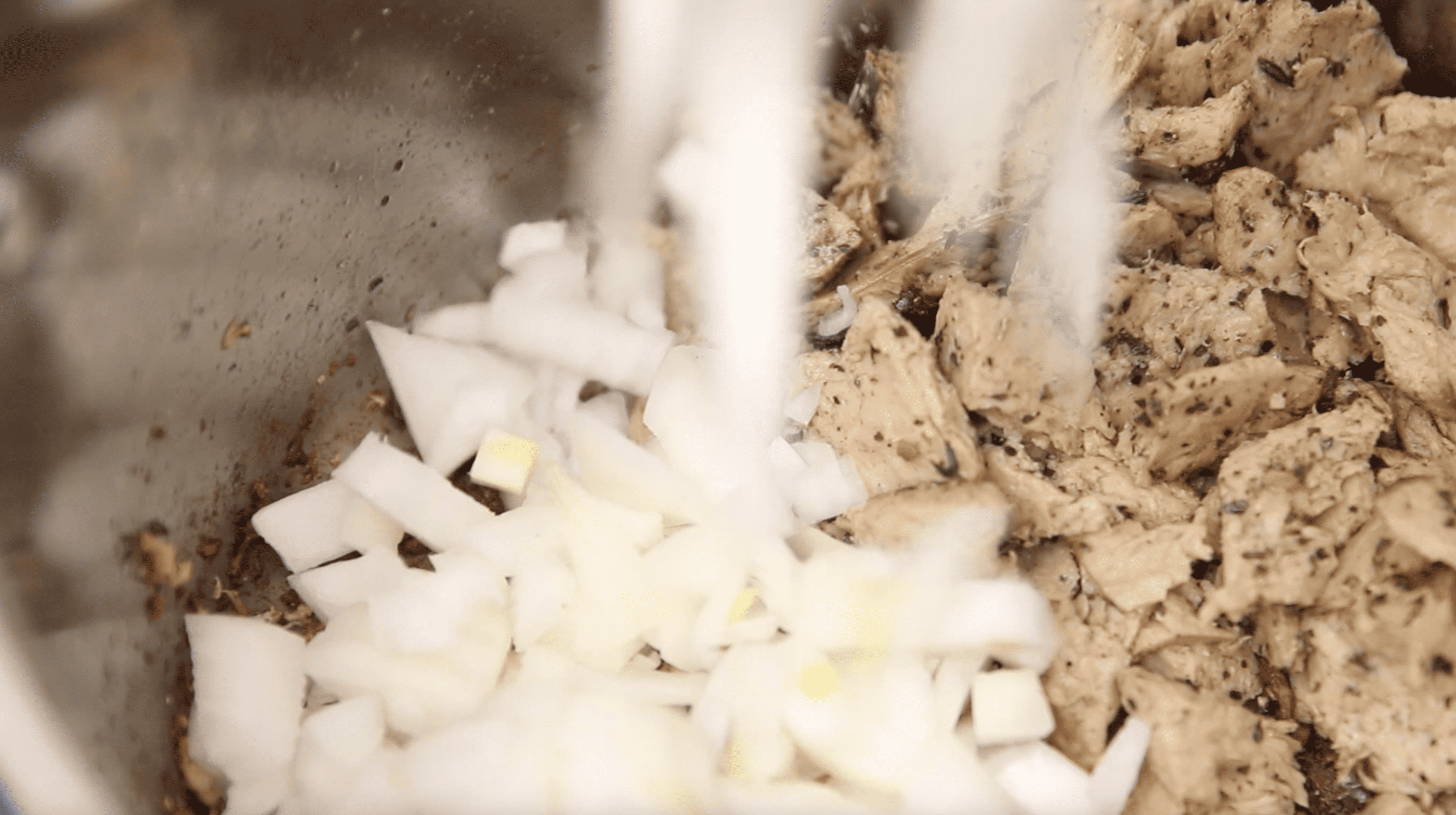 adding chopped onion to vegan chicken noodle soup