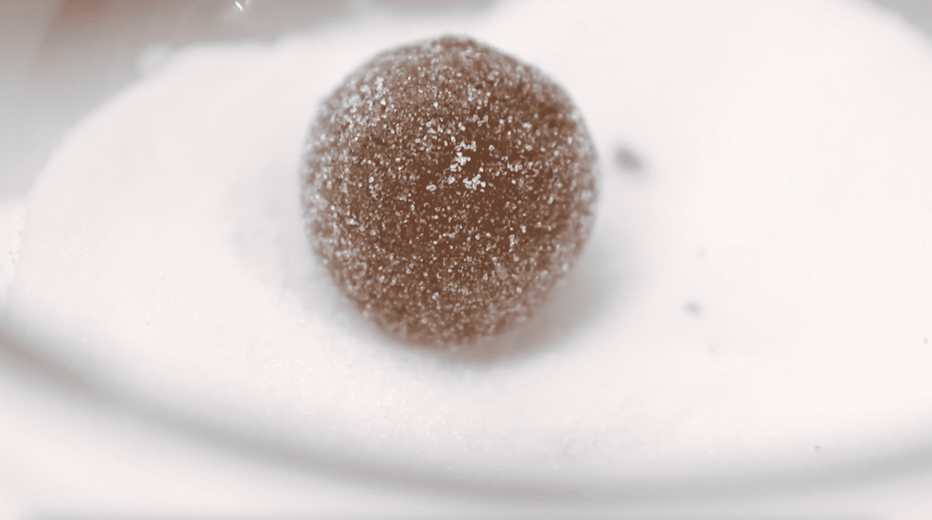 ball of cookie dough rolled in sugar