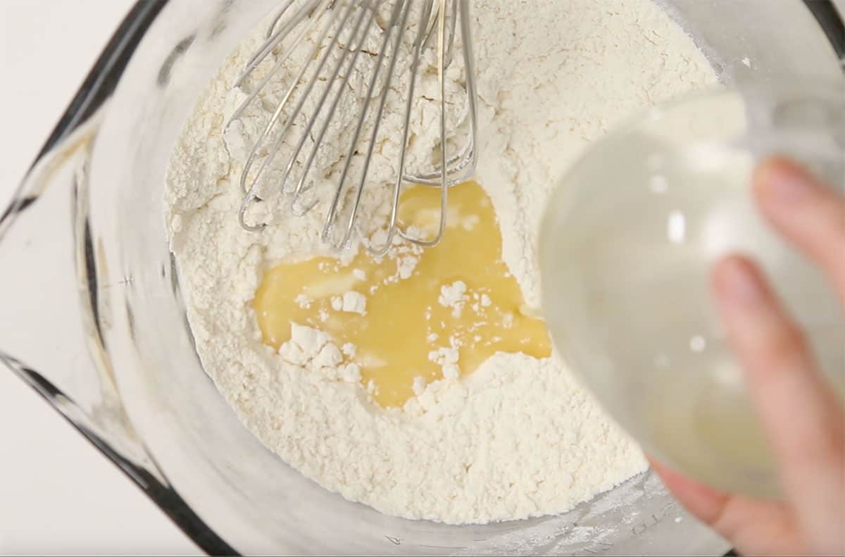 flour and vegan butter being whisked together in a bowl