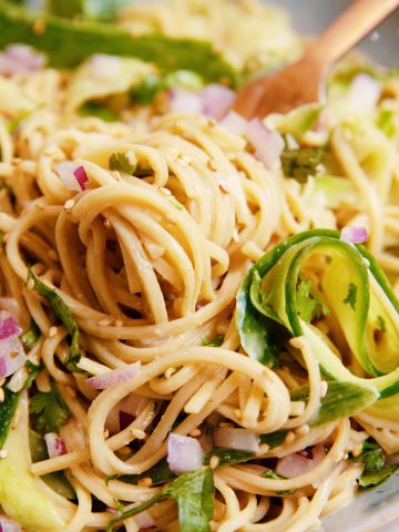 close up of fork twirled with creamy cucumber soba noodles