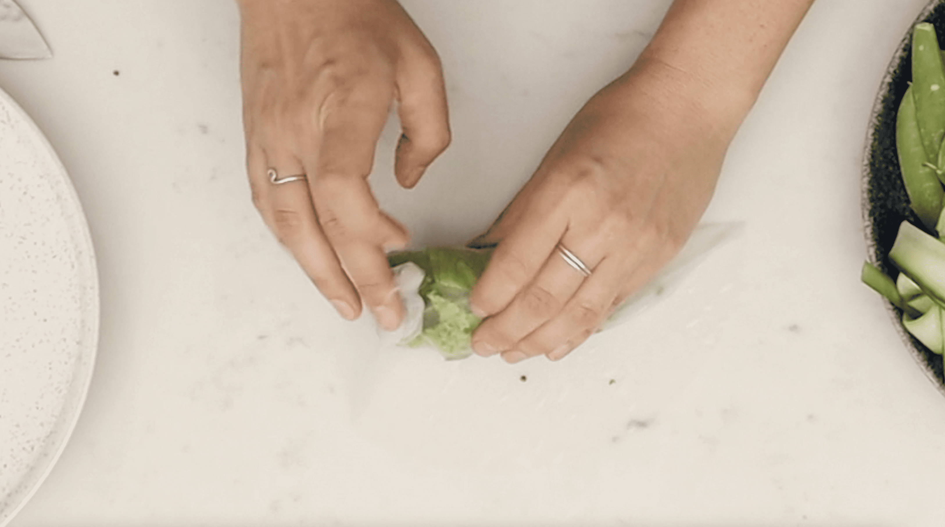 hands rolling vegan summer roll