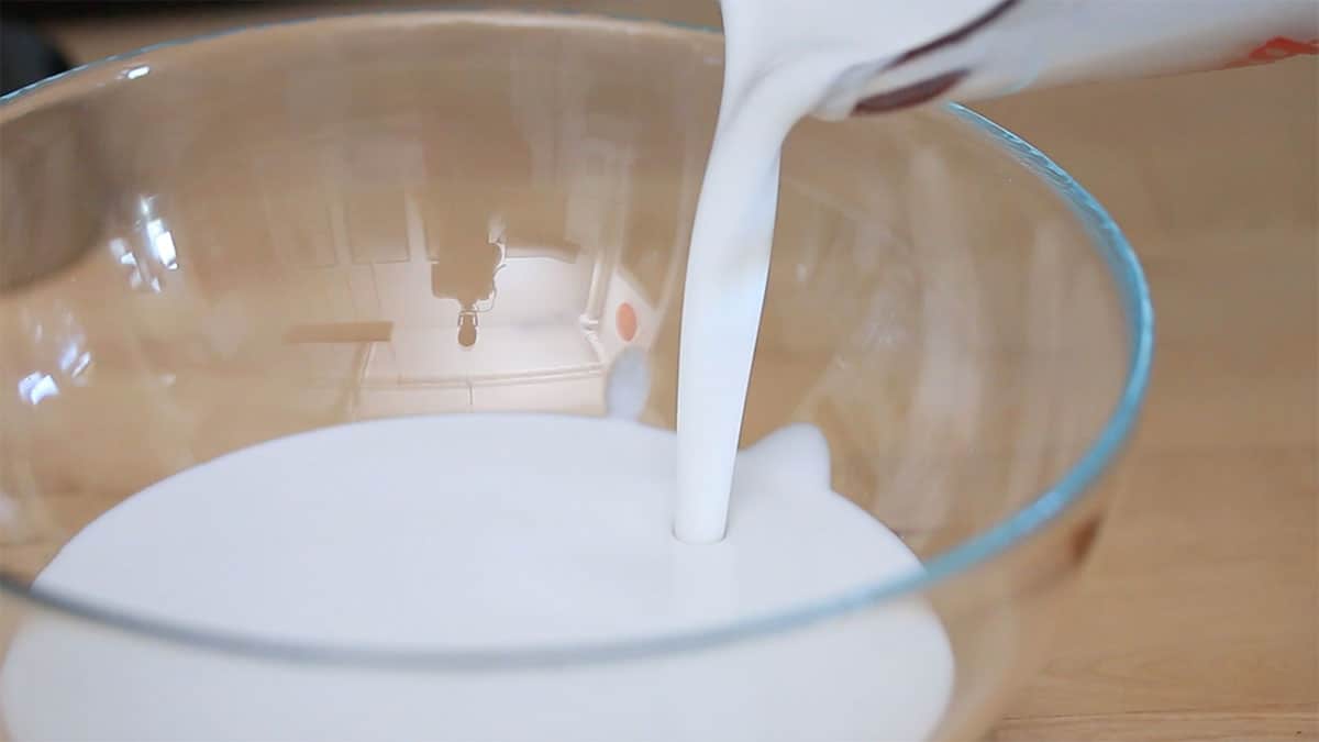 mixing bowl with coconut milk being poured into it