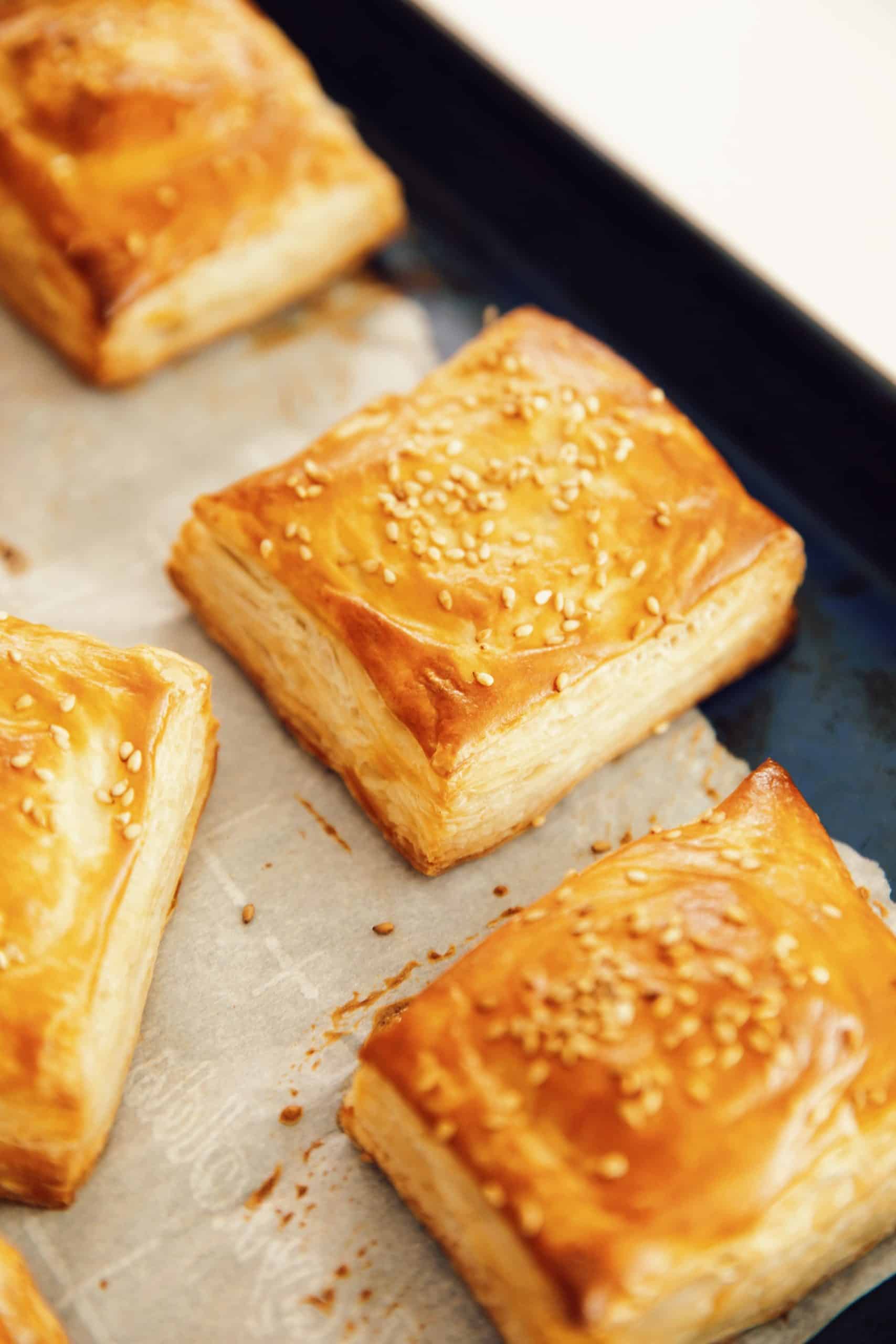 baked vegan ham and cheese croissants on a baking sheet